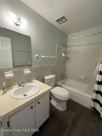 a view of house with garden and tall tress