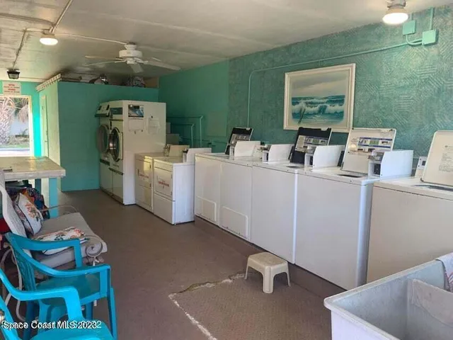 an aerial view of residential houses with outdoor space and swimming pool