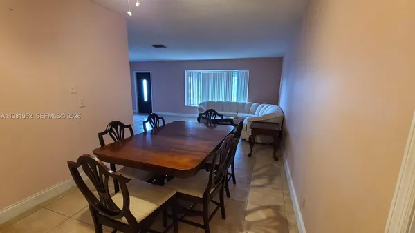 a view of a dining room with furniture and window