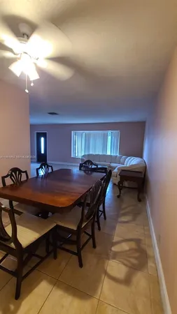 a living room with furniture a rug and a chandelier