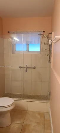a bathroom with a shower and a toilet