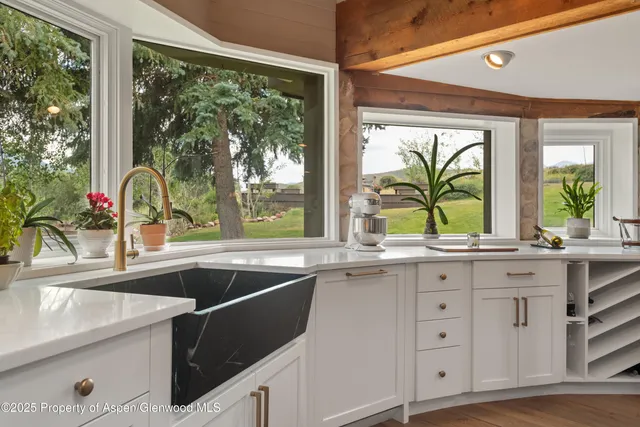 a kitchen with a sink and large window