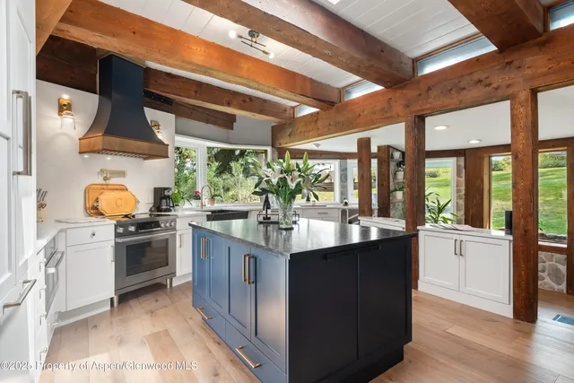 a kitchen with stainless steel appliances granite countertop a sink and stove