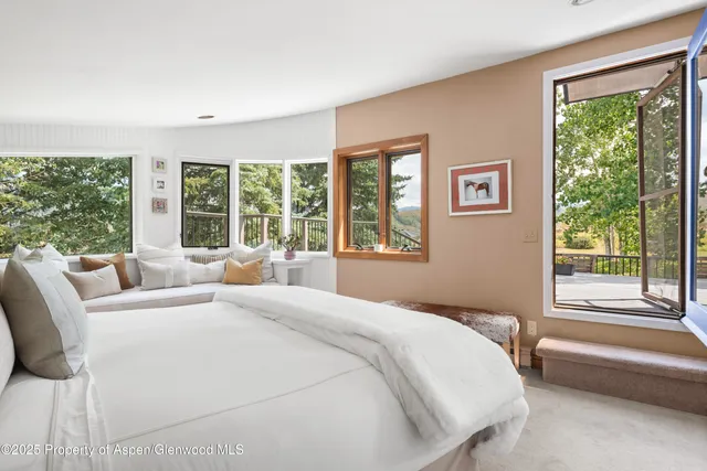 a bedroom with a large bed and a large window