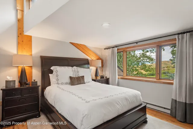 a bedroom with a large bed and a window