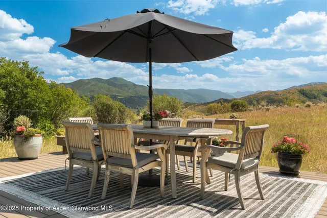 a view of a patio with furniture and table