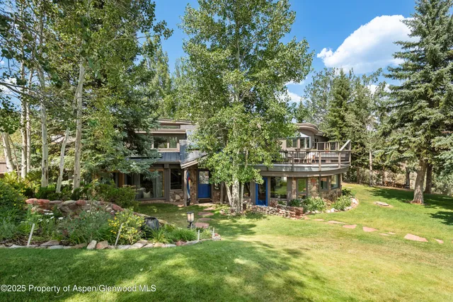 a view of a house with a yard balcony and sitting area