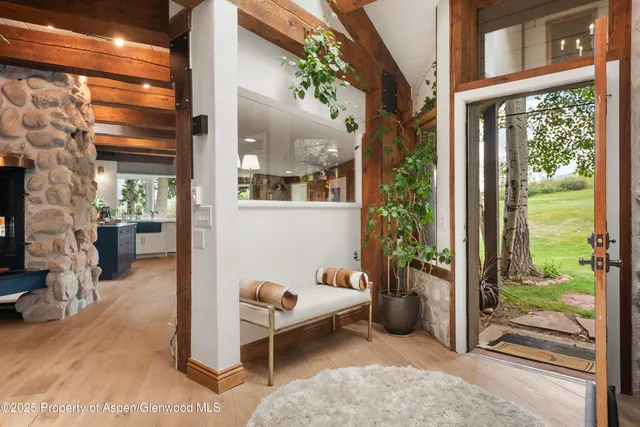 a view of a porch with chairs and potted plants