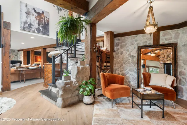 a living room filled with furniture and a potted plant