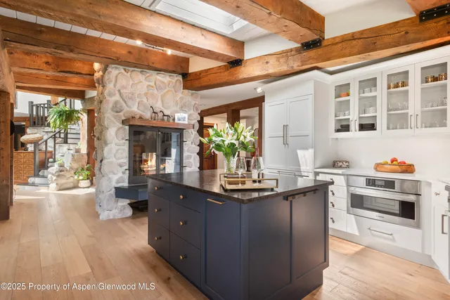 a kitchen with stainless steel appliances granite countertop a sink and wooden cabinets
