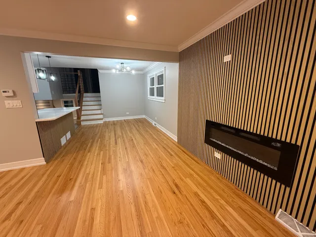 a view of a room with wooden floor