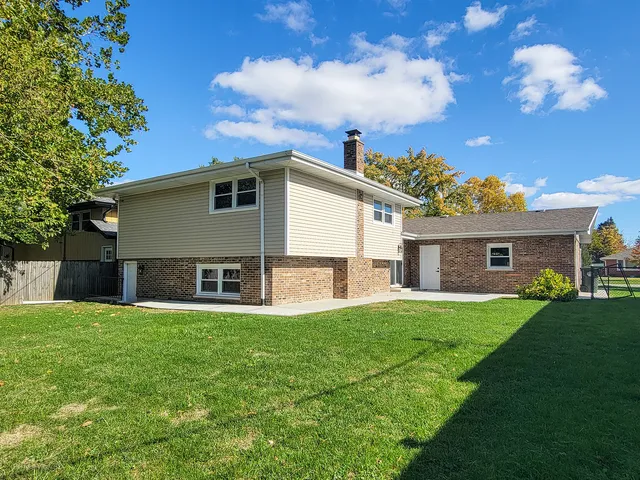 a house view with a sitting space and garden