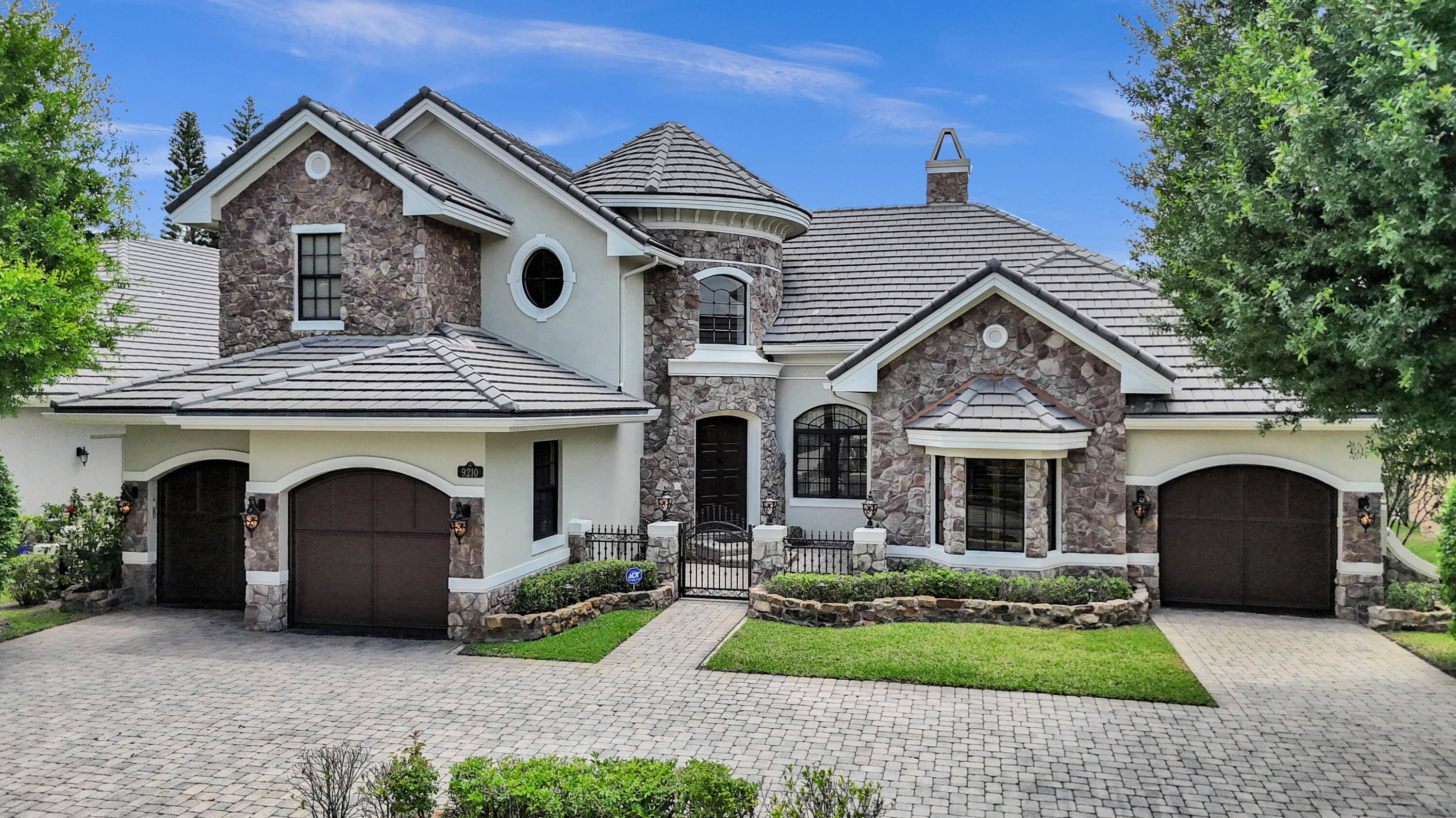 a front view of a house with a garden