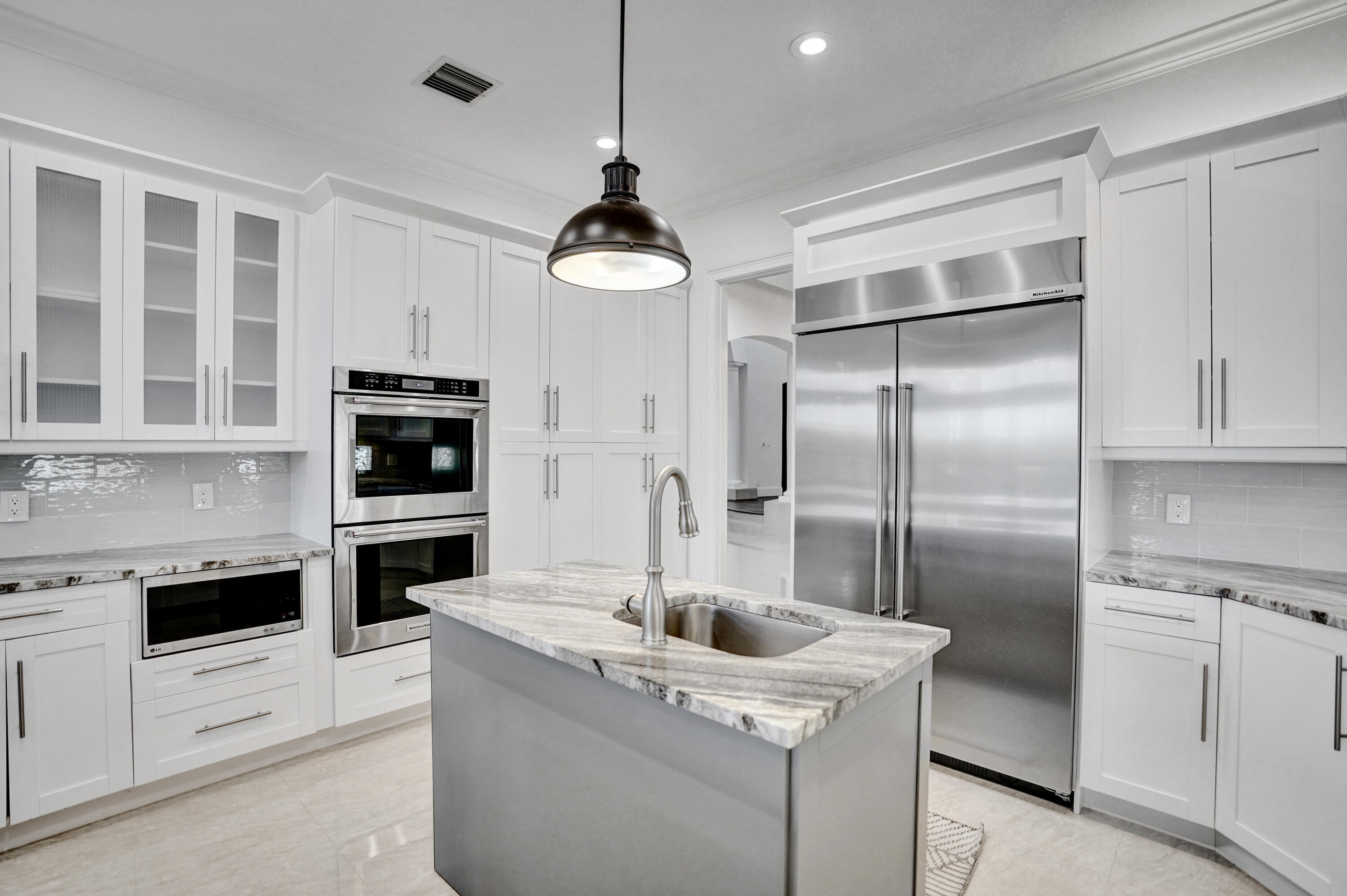 9210 Equus Circle Boynton Beach, FL 33472 - Photo 20 of 75 a kitchen with stainless steel appliances kitchen island a refrigerator and a stove