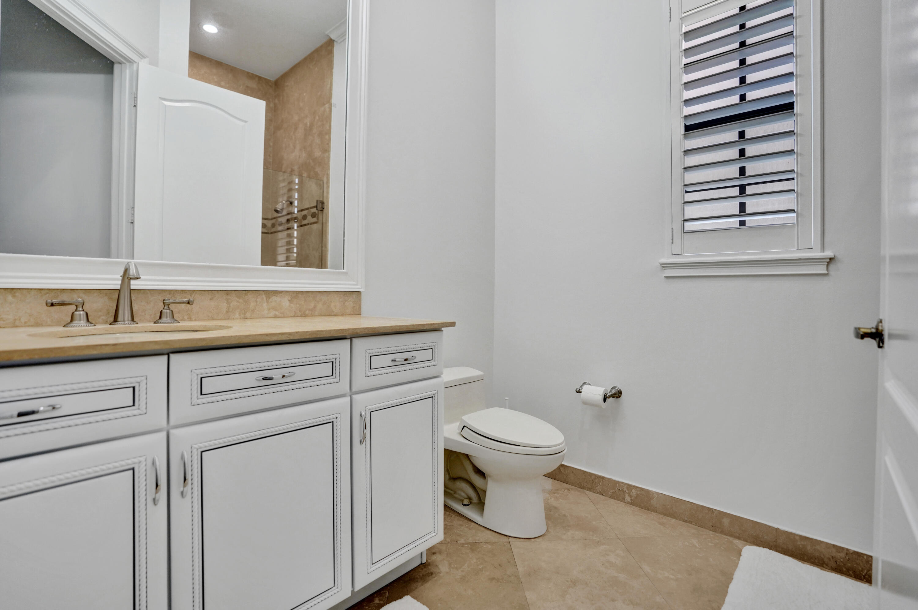 9210 Equus Circle Boynton Beach, FL 33472 - Photo 27 of 75 a bathroom with a sink toilet and mirror