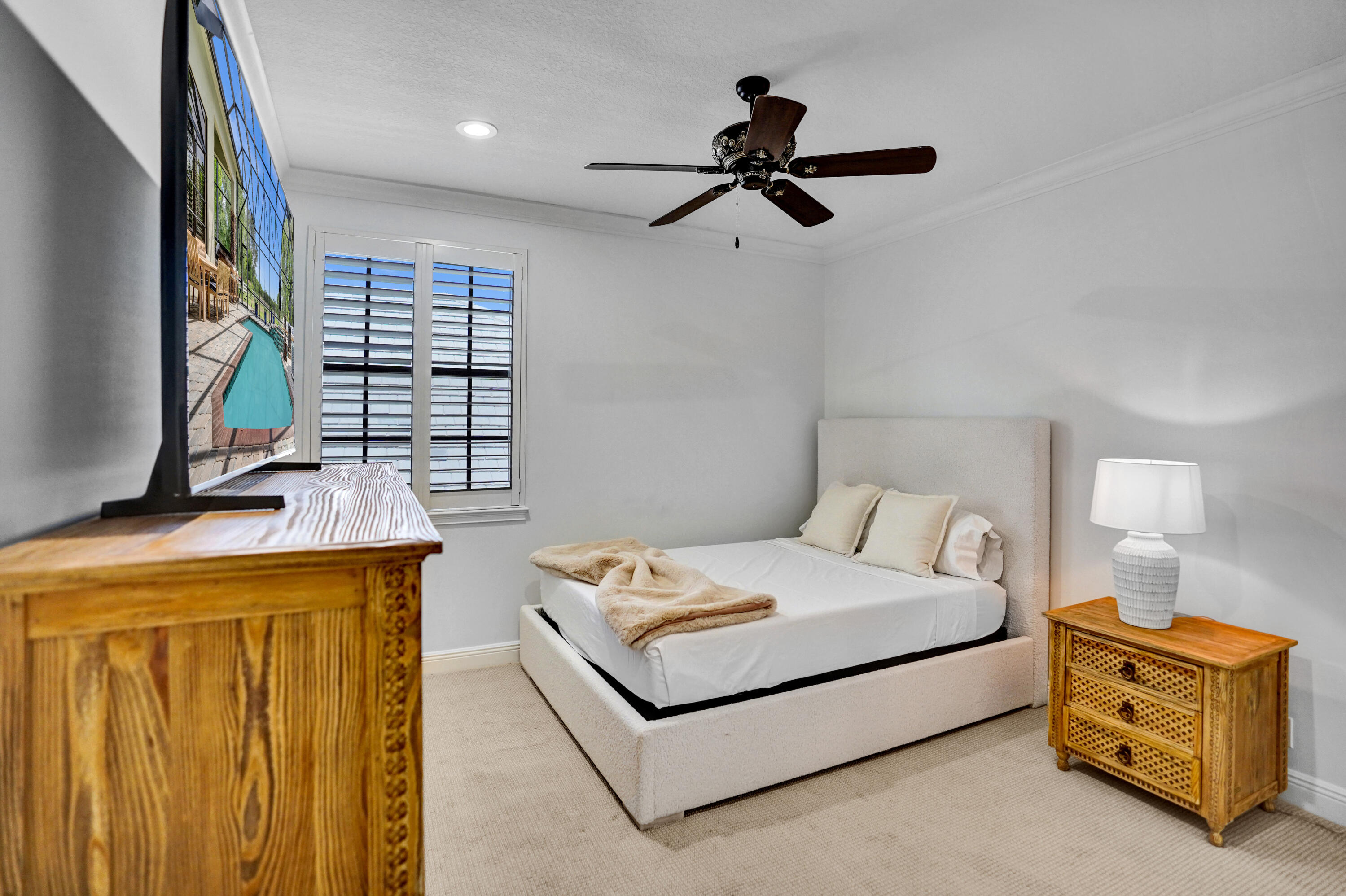 9210 Equus Circle Boynton Beach, FL 33472 - Photo 37 of 75 a bedroom with a bed and a flat tv screen on dresser
