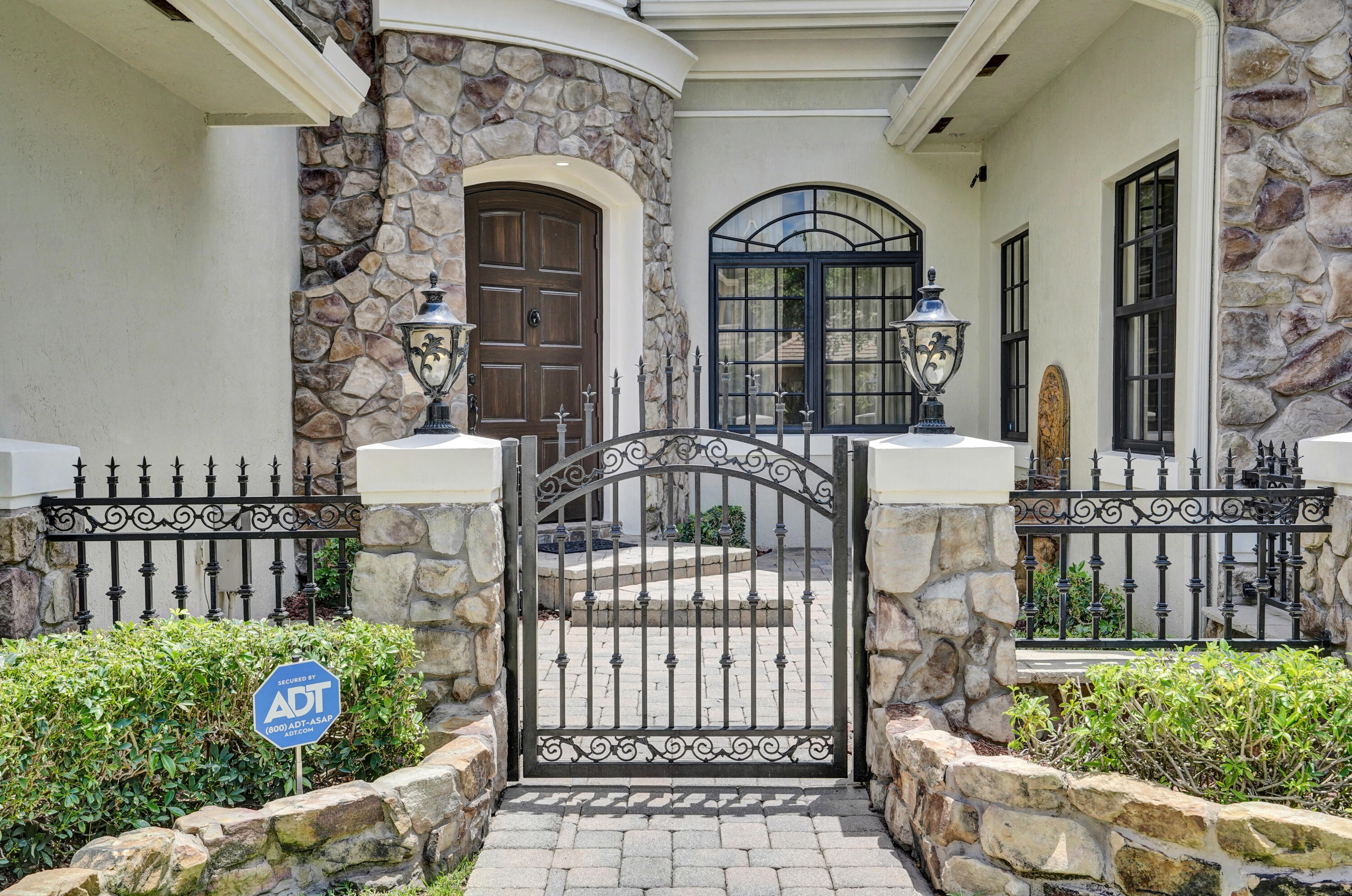 9210 Equus Circle Boynton Beach, FL 33472 - Photo 5 of 75 a front view of a house with a garden