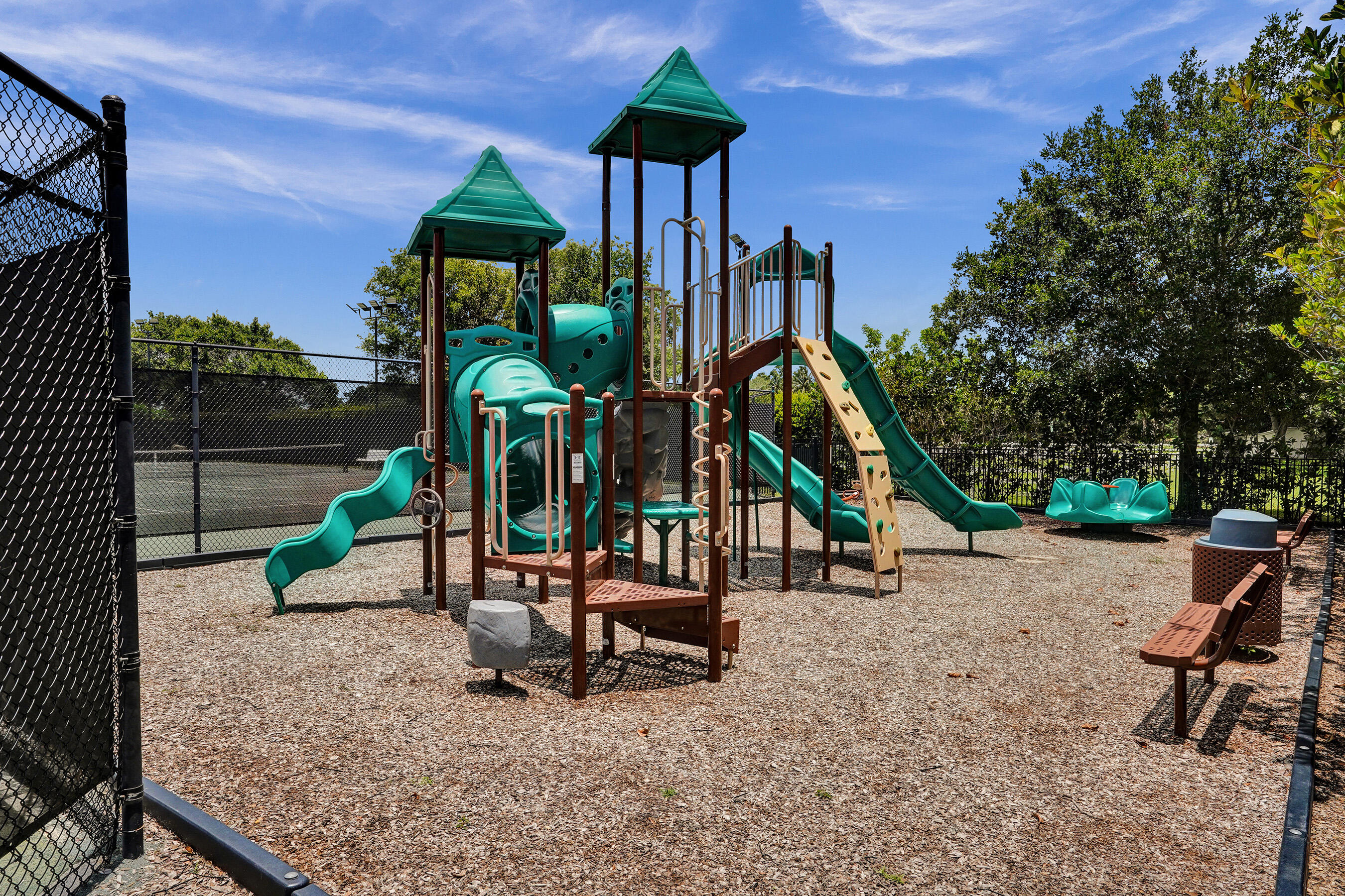 9210 Equus Circle Boynton Beach, FL 33472 - Photo 68 of 75 a childrens park with lots of swings and slides
