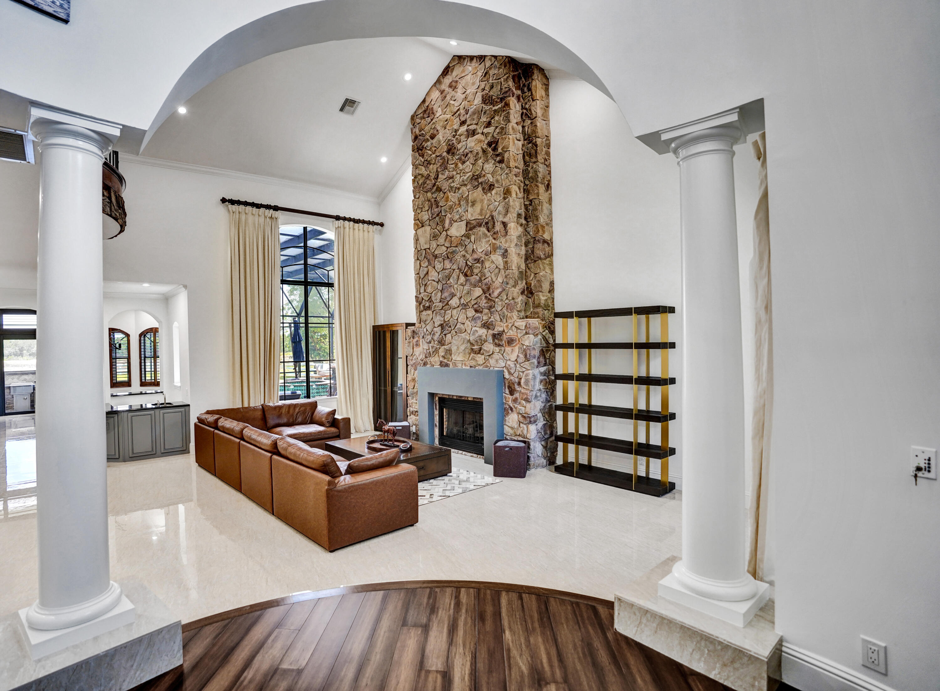 9210 Equus Circle Boynton Beach, FL 33472 - Photo 8 of 75 a living room with furniture a fireplace and a flat screen tv