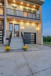 a living room with kitchen island furniture and a chandelier