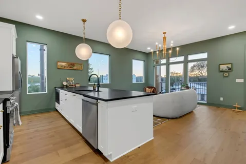a kitchen with stainless steel appliances a sink stove and cabinets