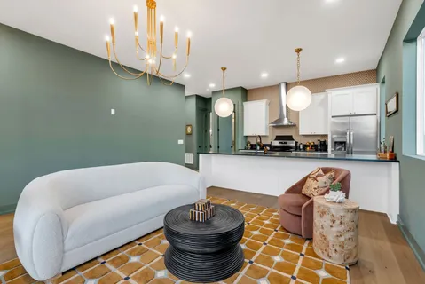 a kitchen with stainless steel appliances granite countertop a sink a stove and a wooden floors