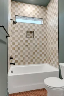 a bathroom with a granite countertop sink a toilet and shower