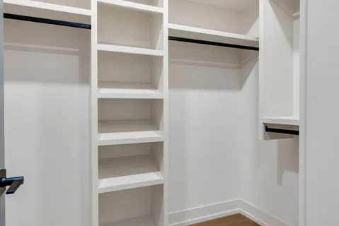 a bedroom with a bed and a lamp