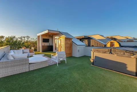 a roof deck with a table and chairs