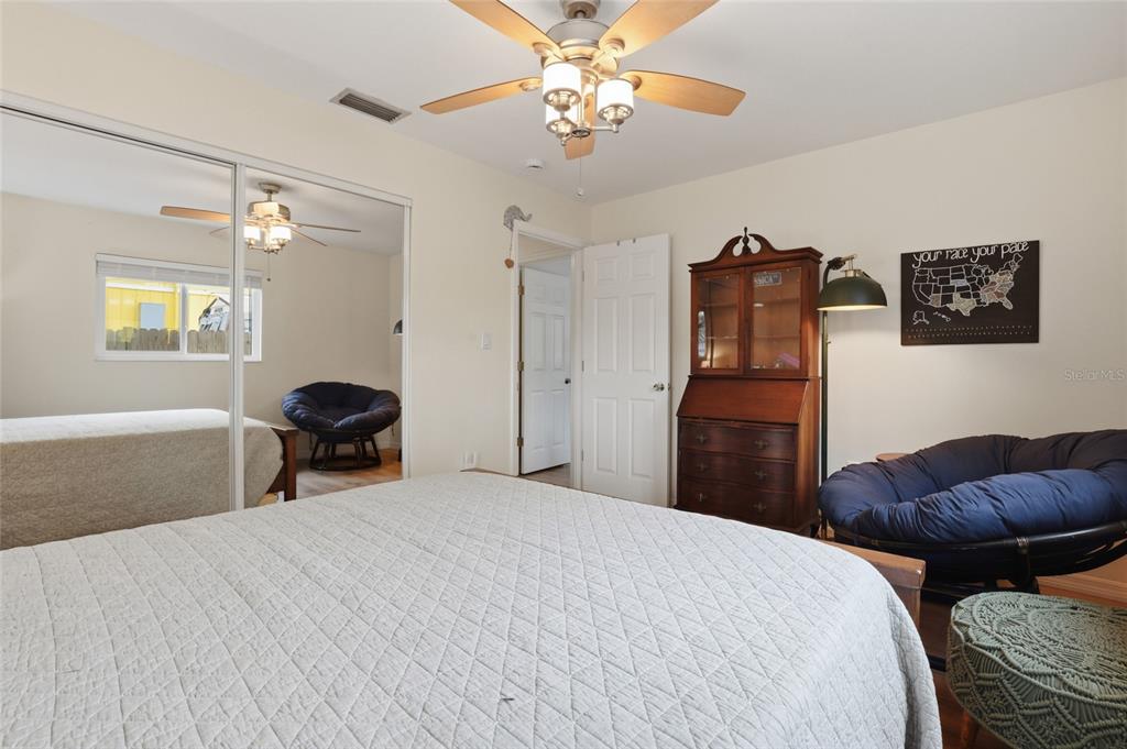 4576 Bliss Road Sarasota, FL 34233 - Photo 25 of 40 a bedroom with a bed and a chandelier