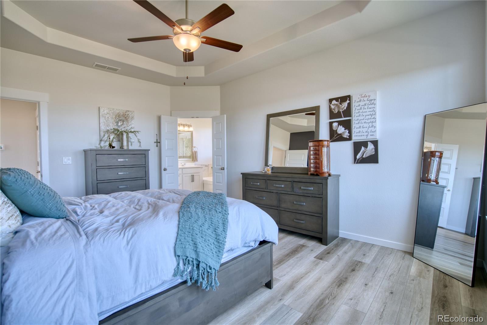 848 Lowrey Lane Berthoud, CO 80513 - Photo 12 of 36 a bedroom with a bed and wooden floor