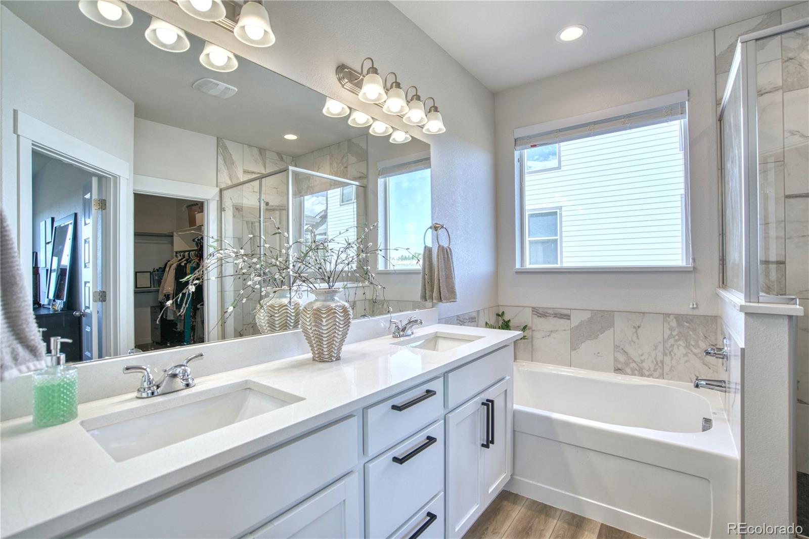 848 Lowrey Lane Berthoud, CO 80513 - Photo 13 of 36 a bathroom with a tub sink and mirror