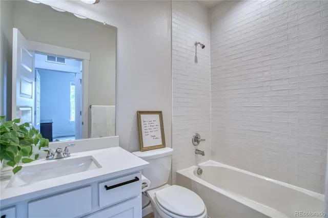 a bathroom with a sink toilet a mirror and shower