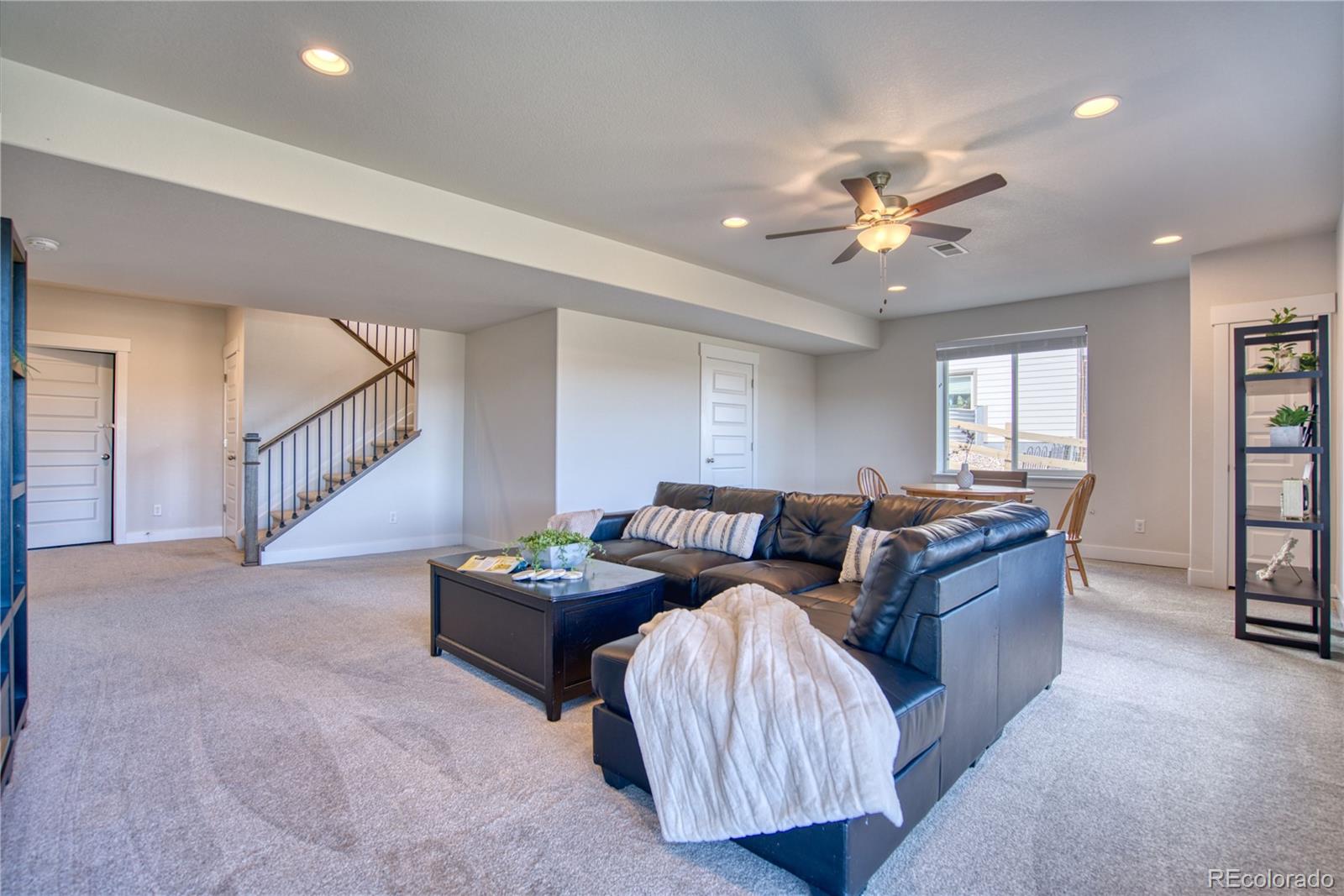 848 Lowrey Lane Berthoud, CO 80513 - Photo 20 of 36 a living room with furniture and stairs