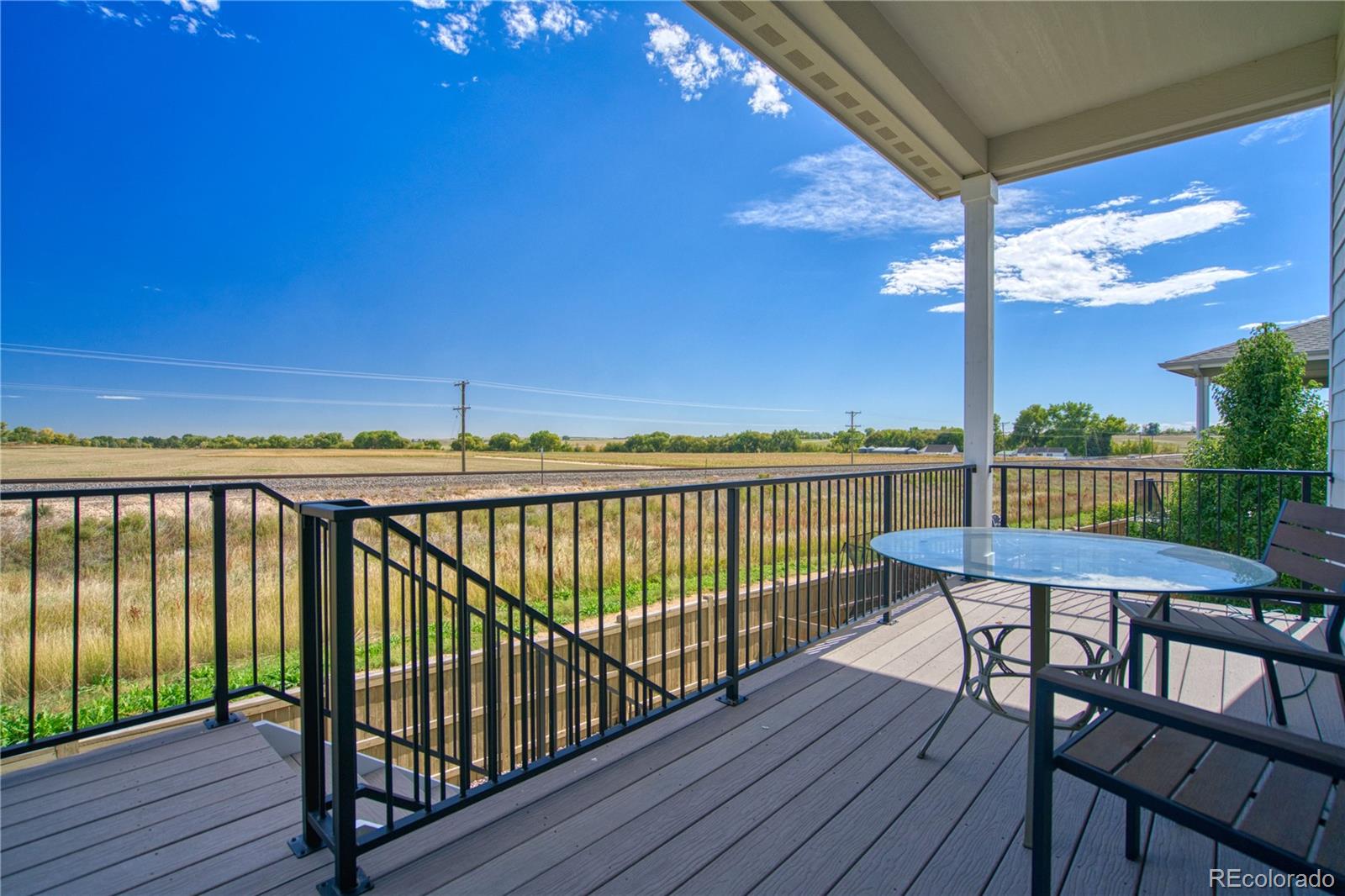 848 Lowrey Lane Berthoud, CO 80513 - Photo 30 of 36 a view of a balcony with wooden floor and outdoor seating