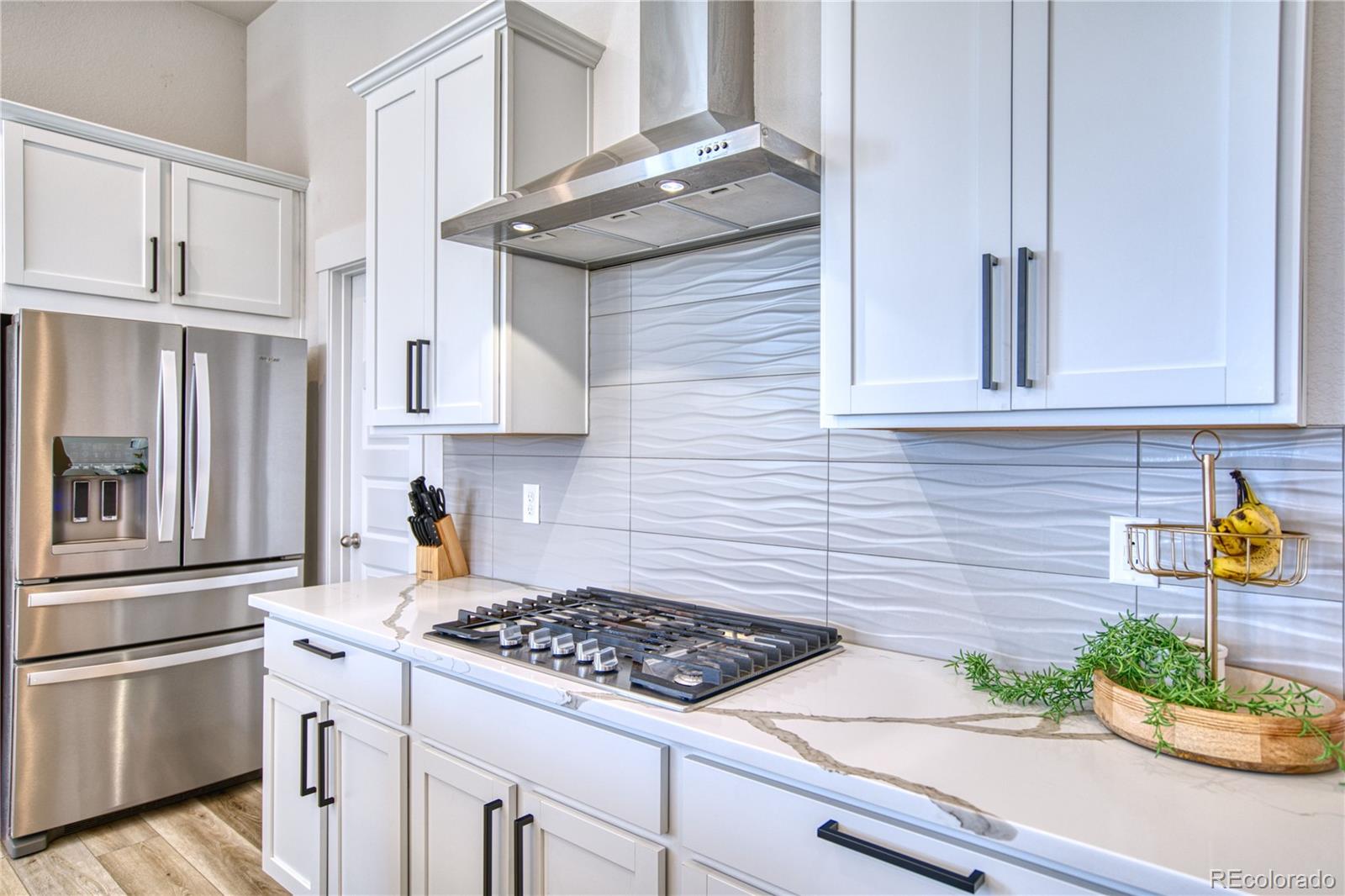 848 Lowrey Lane Berthoud, CO 80513 - Photo 4 of 36 a kitchen with stainless steel appliances granite countertop white cabinets and a stove