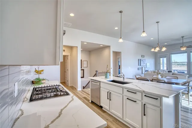 a kitchen with kitchen island white cabinets and white appliances