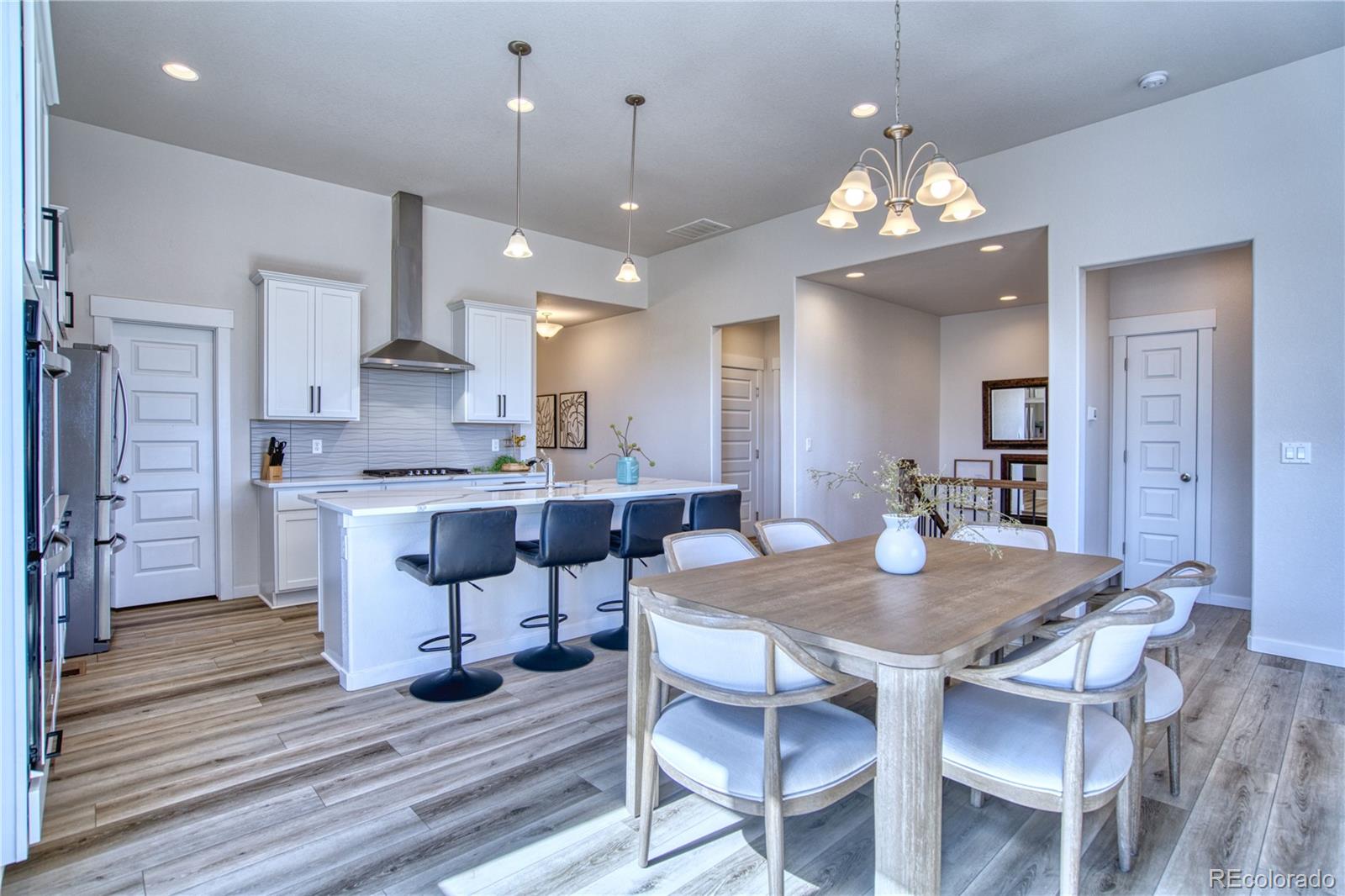 848 Lowrey Lane Berthoud, CO 80513 - Photo 6 of 36 a view of a dining room with furniture and wooden floor