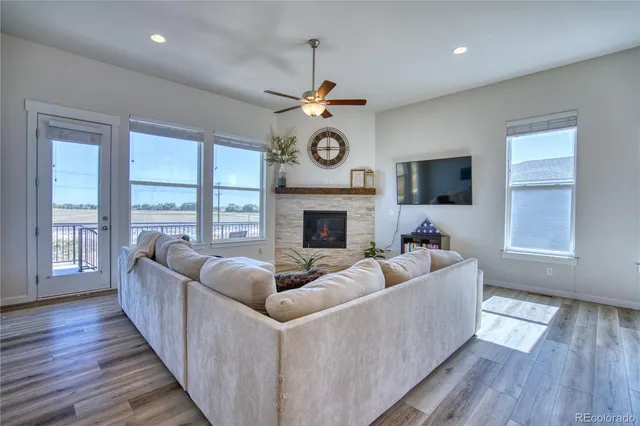 a living room with furniture a fireplace and a flat screen tv