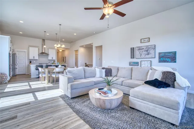 a living room with furniture and a chandelier