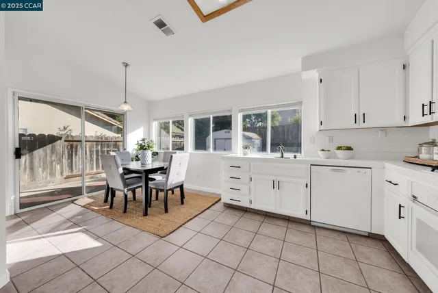 a dining room filled counter top space and a kitchen view