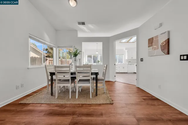 a view of a dining room with furniture and a potted plant