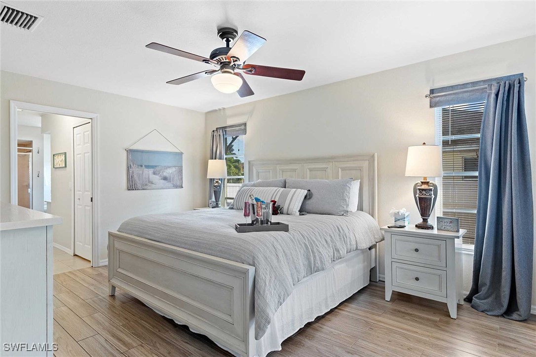 4810 Southwest 25th Place Cape Coral, FL 33914 - Photo 11 of 29 a bedroom with a large bed and a chandelier