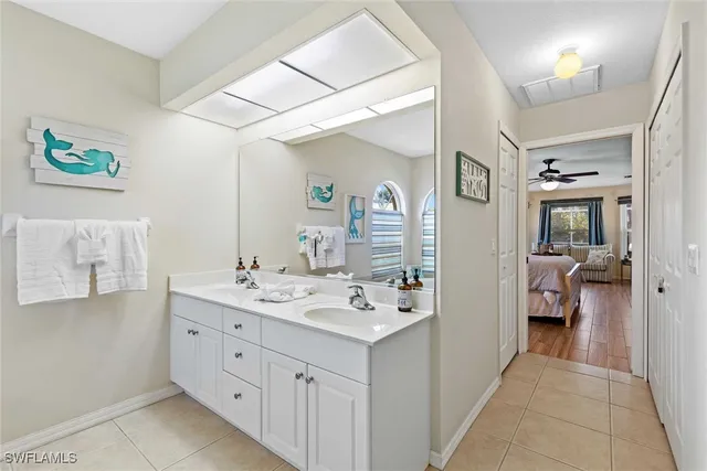 a en suite bathroom with a sink a mirror and a shower