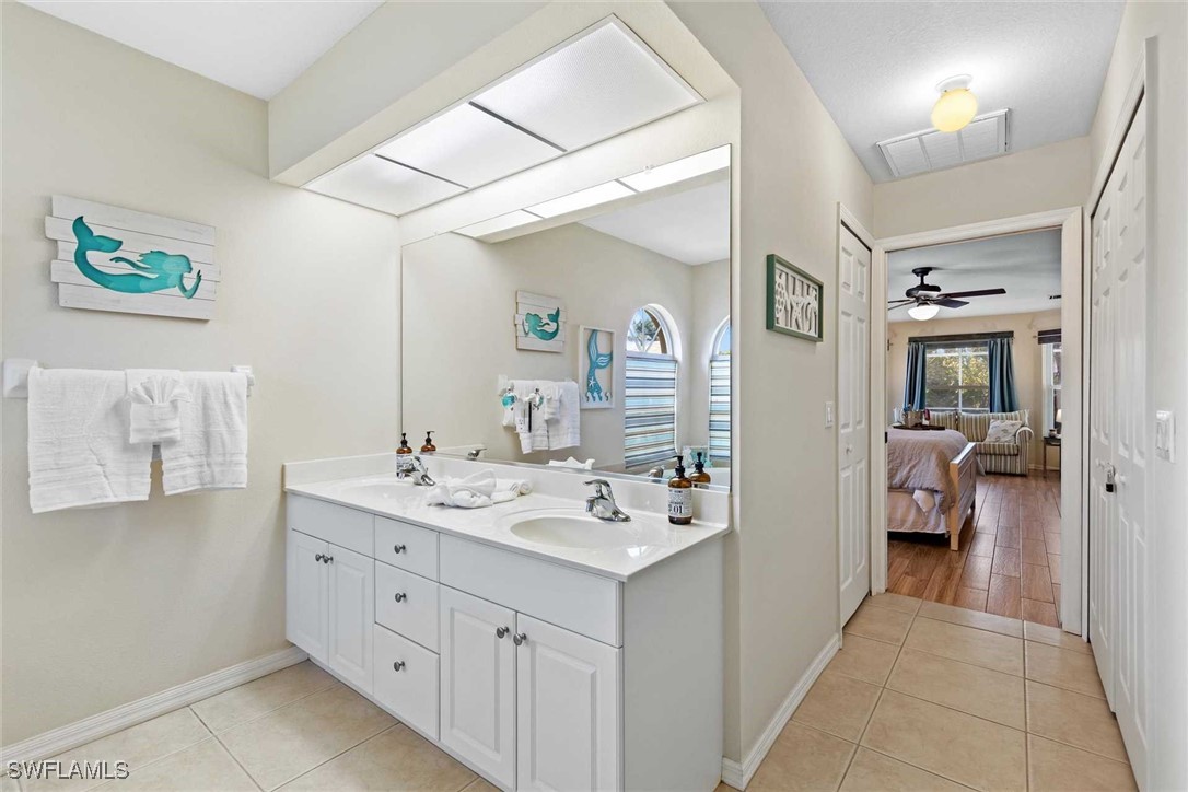 4810 Southwest 25th Place Cape Coral, FL 33914 - Photo 15 of 29 a en suite bathroom with a sink a mirror and a shower