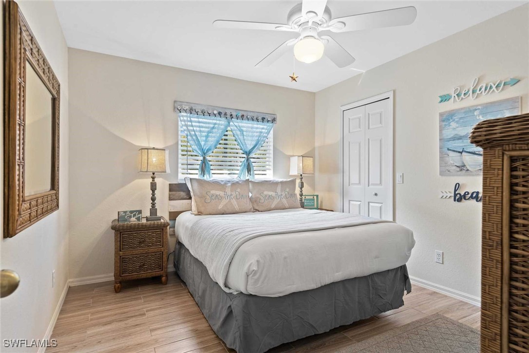 4810 Southwest 25th Place Cape Coral, FL 33914 - Photo 17 of 29 a bedroom with a bed and a chandelier