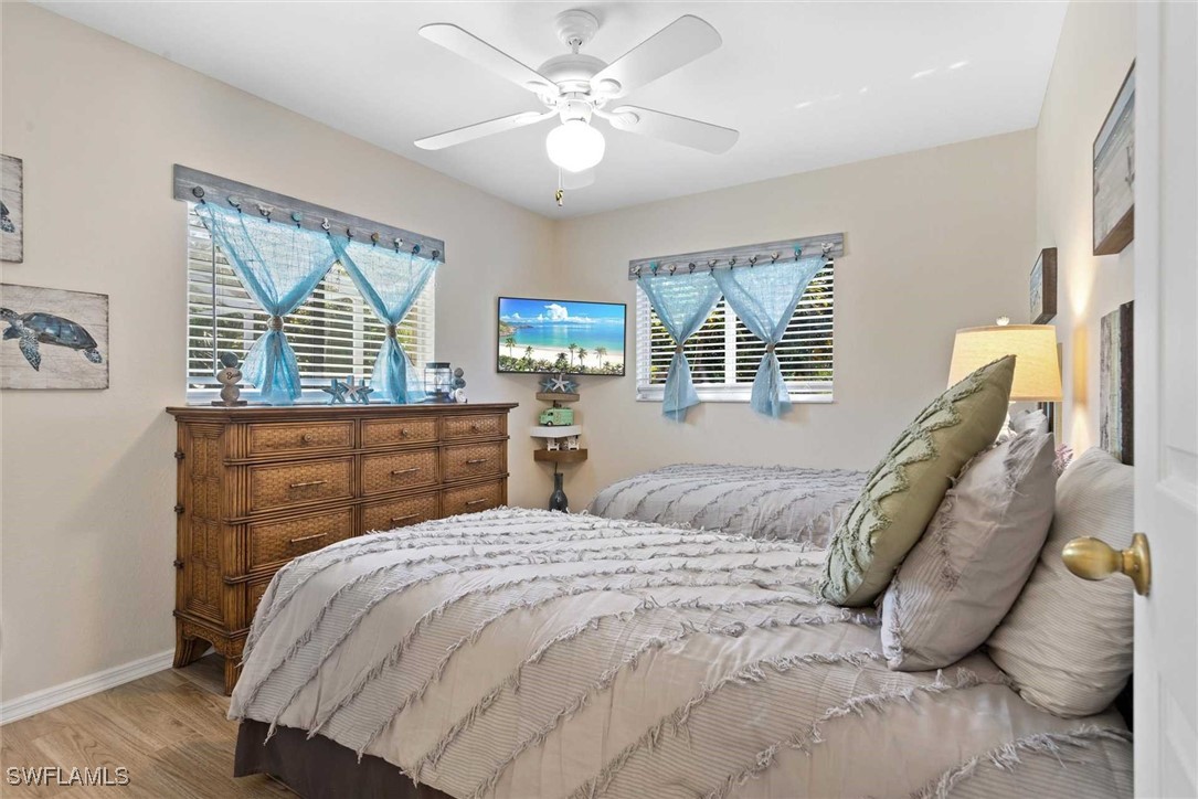 4810 Southwest 25th Place Cape Coral, FL 33914 - Photo 18 of 29 a bedroom with a large bed and a large window