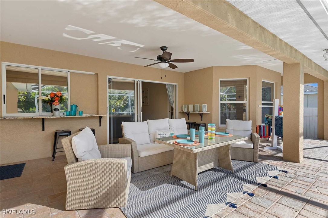 4810 Southwest 25th Place Cape Coral, FL 33914 - Photo 23 of 29 a living room with furniture and a chandelier