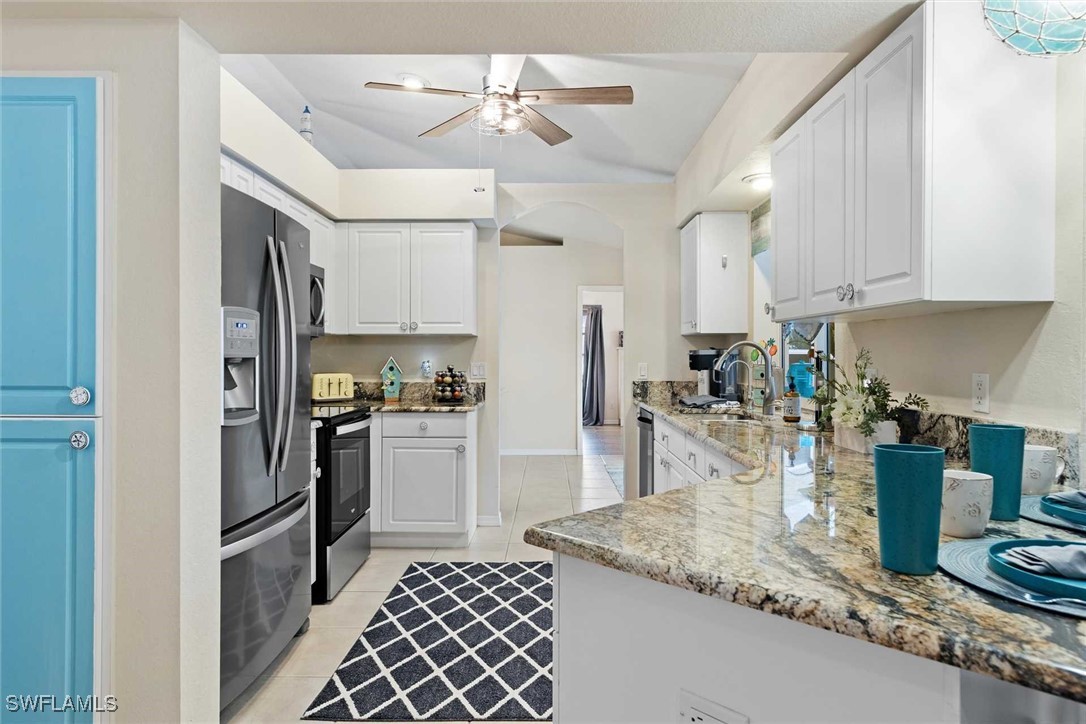 4810 Southwest 25th Place Cape Coral, FL 33914 - Photo 29 of 29 a kitchen with refrigerator and cabinets