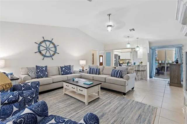 a living room with furniture or couch and a view of kitchen